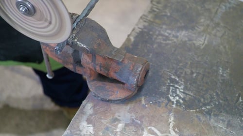 Man Works Circular Saw. Flies of Spark From Hot Metal. The Man's Hard Work