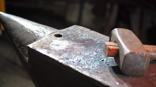 Red Hot Metal Being Hammered on Anvil