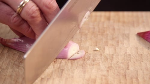 Dicing Shallot with Knife on Cutting Board
