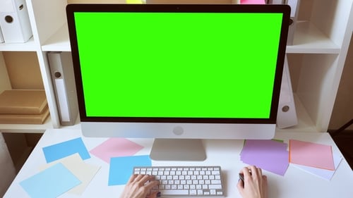 Woman Uses Computer with Green Screen Monitor