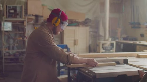 Man Working with Table Saw in Workshop