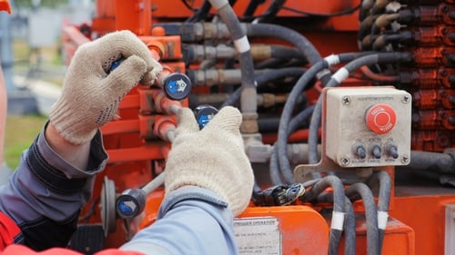 Electrician Moves Control Levers in Power Box