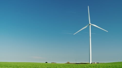Idyllicistic Landscape of a Green Meadow and a Wind Generator. Ecology and Environment Concept. 1