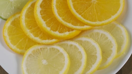 Colorful Citrus Fruit Slices on a White Plate