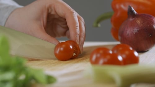 Chopping Fresh Cherry Tomatoes for a Healthy Meal