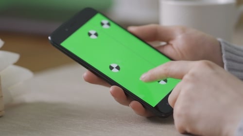 Green screen Chroma Key on Smartphone screen, with female hands