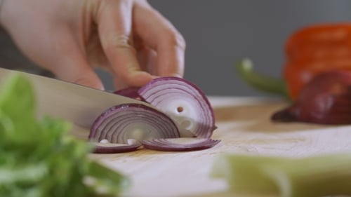 Slicing Fresh Red Onion on Cutting Board