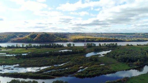 Distant Electric Tower Supports Power Line Against River