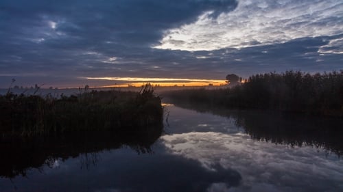 See im Frühling im Morgengrauen. Reflexion von Wolken im Wasser