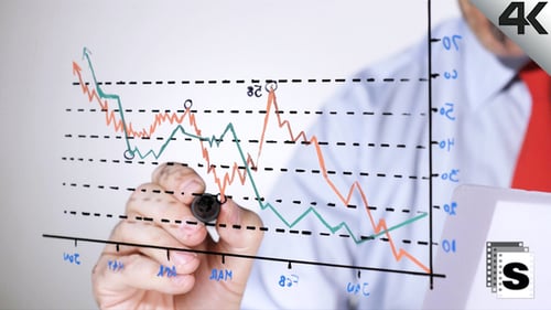 Man Drawing Business Charts on Glass Surface