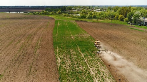 Aerial Footage of a Tractor on a Field