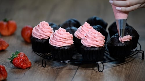 Cupcakes Decorated With Pink Frosting in a Kitchen