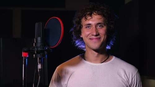 Young Singer Man Showing Gesture Thumb Up in the Studio