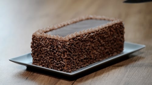 Chocolate Cake Being Cut With a Knife