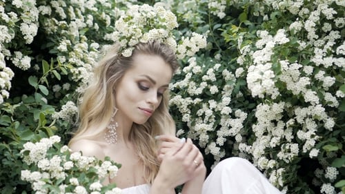 Beautiful Woman in White Dress with Flowers