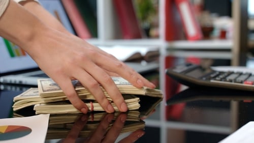Stacks of Cash Placed on Office Desk