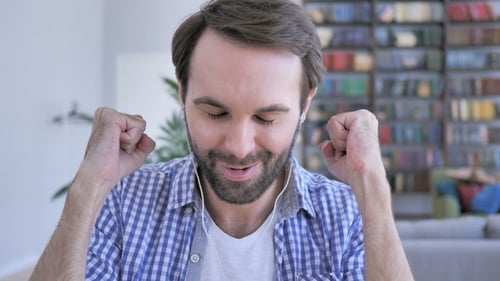 Happy Casual Beard Man Listening Music on Headphones and Dancing with Joy