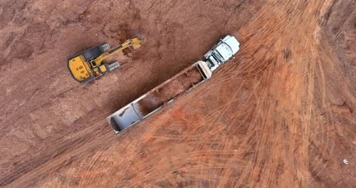 Excavator Loading Truck in Rural Aerial View