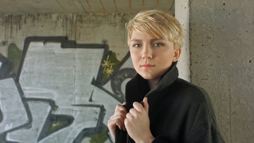 Young Woman with Blonde Hair Near Graffiti Wall