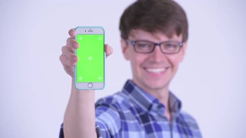 Man Holds Up Chroma Key Smartphone Smiling