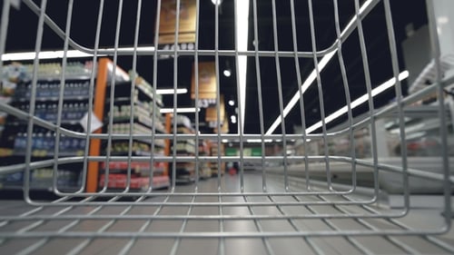 Shopping Trolley Is Moving Quickly Along Aisles in Supermarket