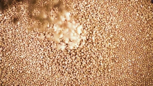 Buckwheat Groats Falling into Heap in Overhead Shot
