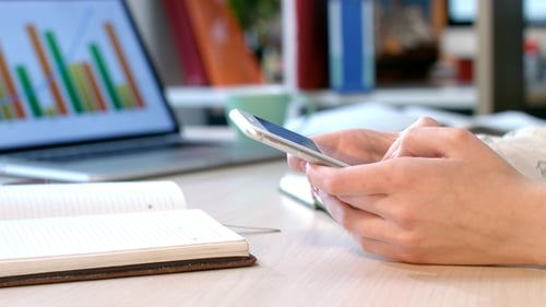 Business Woman Hand Using Smart Phone at Office. Mobile Technology