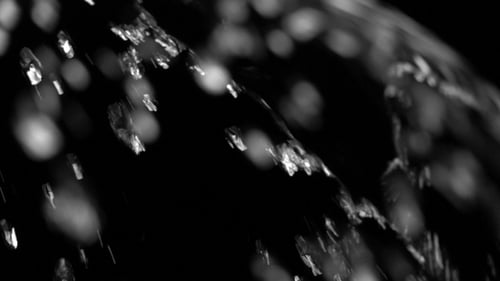 Water Spraying in Macro Against Black Background
