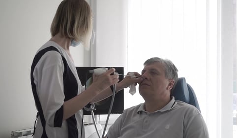Doctor Examine Nose of Old Man with Ent Telescope
