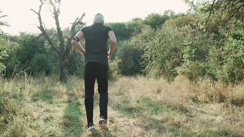 Back View of Male Runner in the Forest