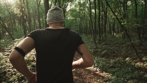 Back View of Male Runner in the Forest