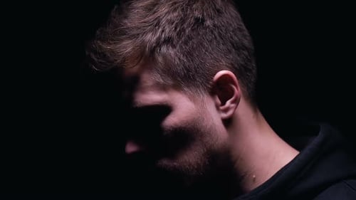 Disappointed Man Looking Into Camera Isolated on Black Background Stress Concept