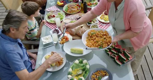 Family eating outside together in summer