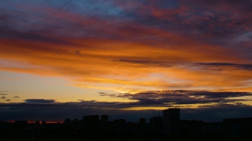 Orange Sunset Dark Blue Clouds Floats By Golden Sky
