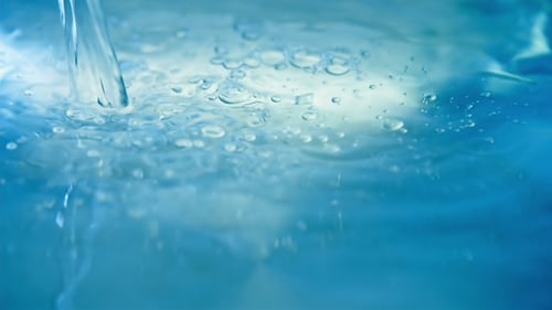 Water Pouring into a Blue Basin