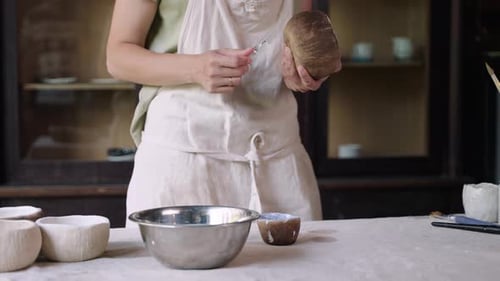 Ceramic Artist Shaping Pottery in Workshop