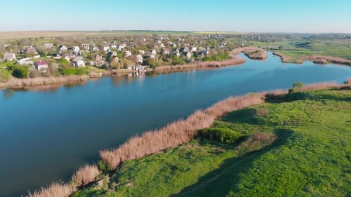 Aerial View of Country Houses on the Hill on Shore of the Pond in the Morning
