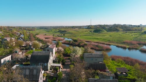Aerial View of Country Houses on the Hill on Shore of the Pond in the Morning