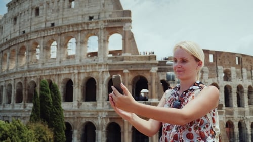 Woman Takes Photo at Colosseum in Rome