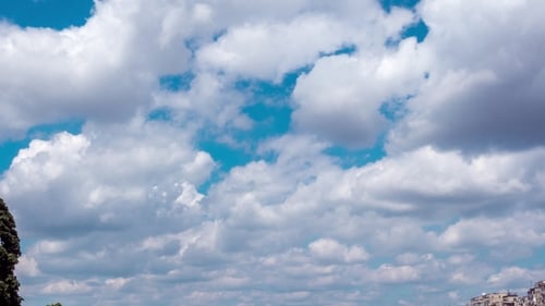 Pan Up Moving Clouds Over City