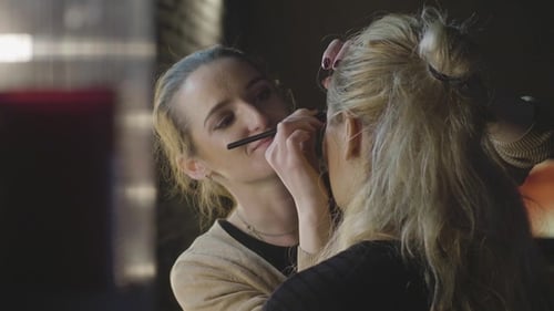 Woman Receiving Makeup Application from Makeup Artist