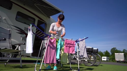 Woman Hanging Laundry at Sunny Campground