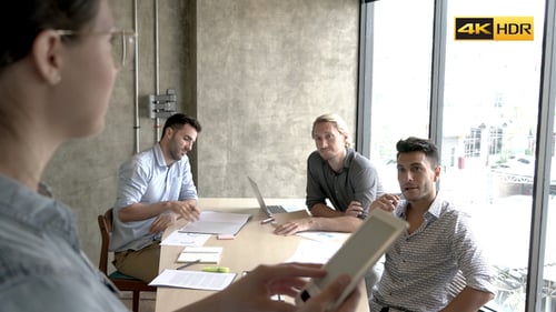 Corporate Team Meeting Around Table in Modern Office