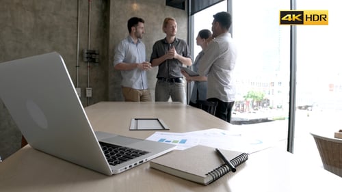 Four Adults Meeting in Urban Office Space