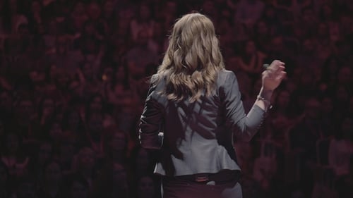 Woman Giving Lecture to Audience at Corporate Event