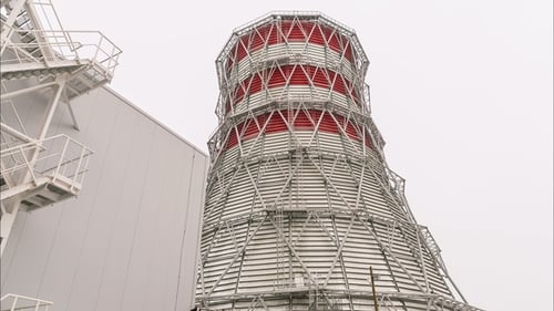 Motion Past Huge Cooling Tower Against Sky