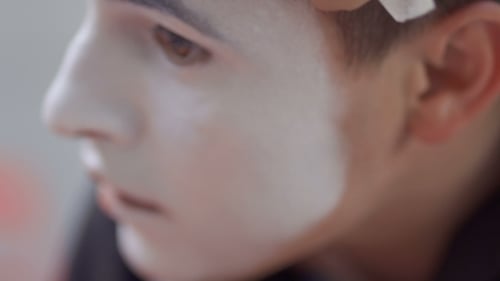 Makeup Artist Applies White Paint to Face