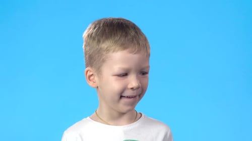 Smiling Boy Close Up on Blue Background