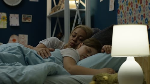 Woman Putting Girl To Sleep