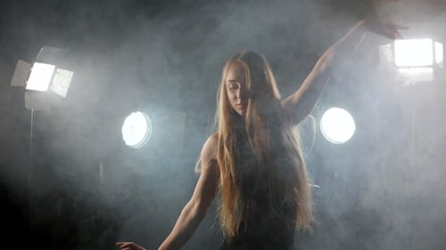 Professional Ballerina Dancing Ballet in Spotlights Smoke on Big Stage. Beautiful Caucasian Young